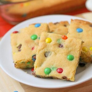 cake mix cookie bars with M&Ms on white plate