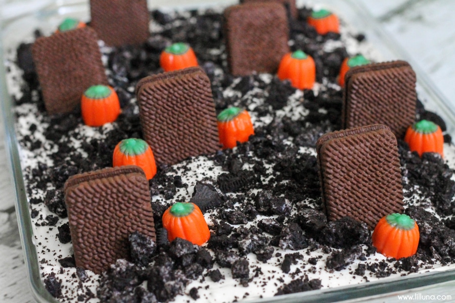 节日蛋糕-墓地泥土蛋糕与糖果南瓜和饼干墓碑。