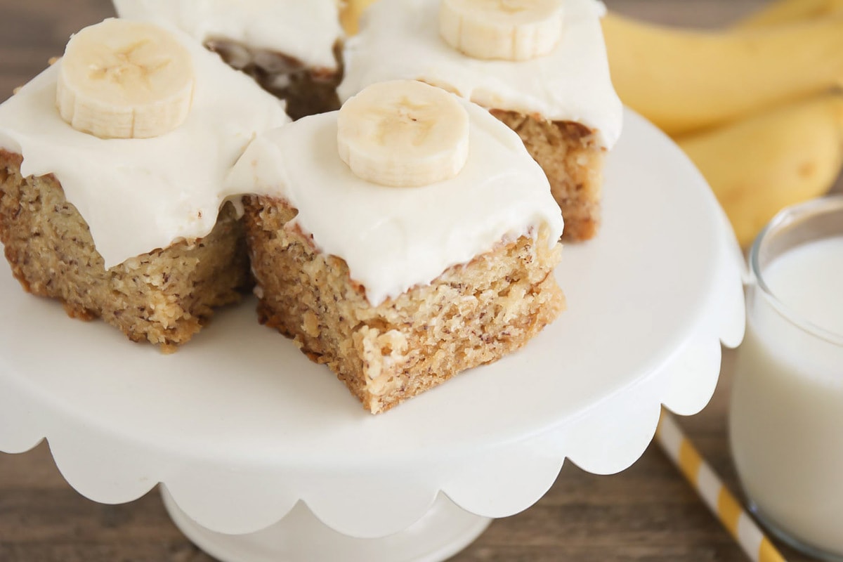 甜点吧食谱-糖霜香蕉条顶bob综合手机客户部香蕉片在一个白色的蛋糕架。