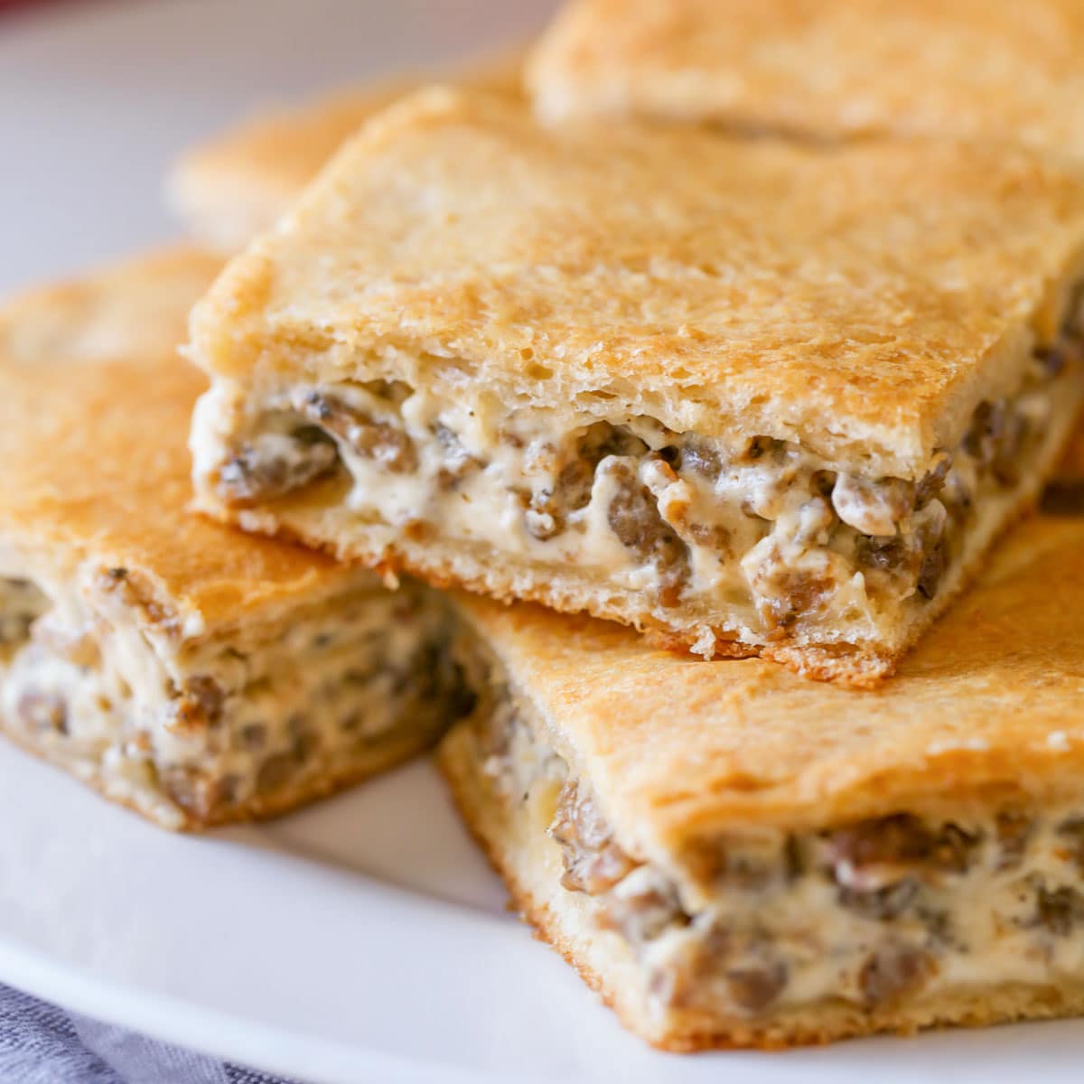 Easy Breakfast Ideas - slices of sausage cream cheese casserole on a white plate.