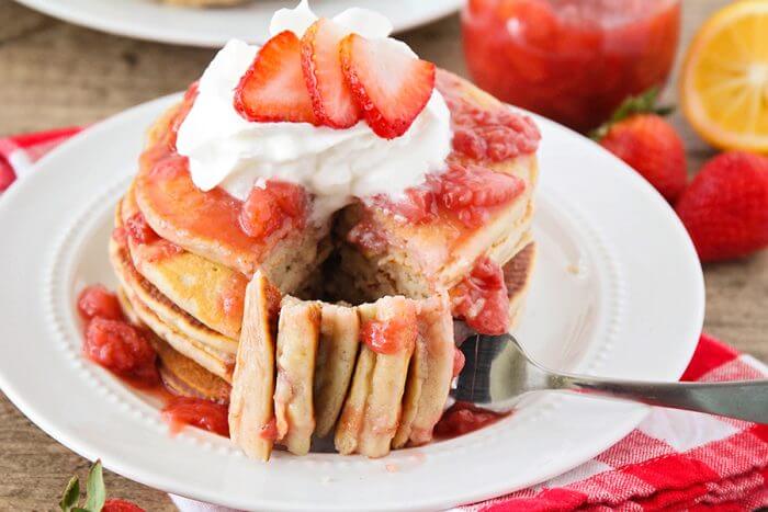 草莓煎饼放在白盘子里，切一块出来