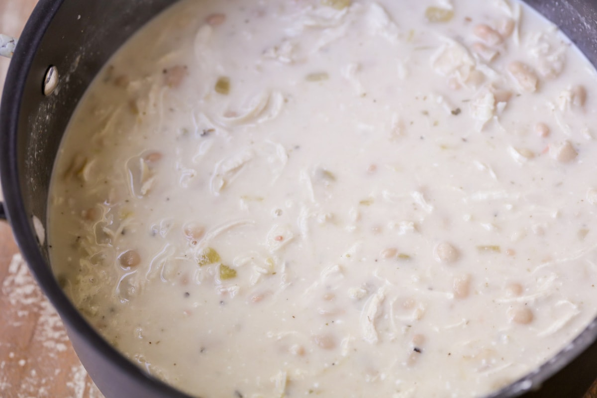 White Chili cooking in a pot on the stove.