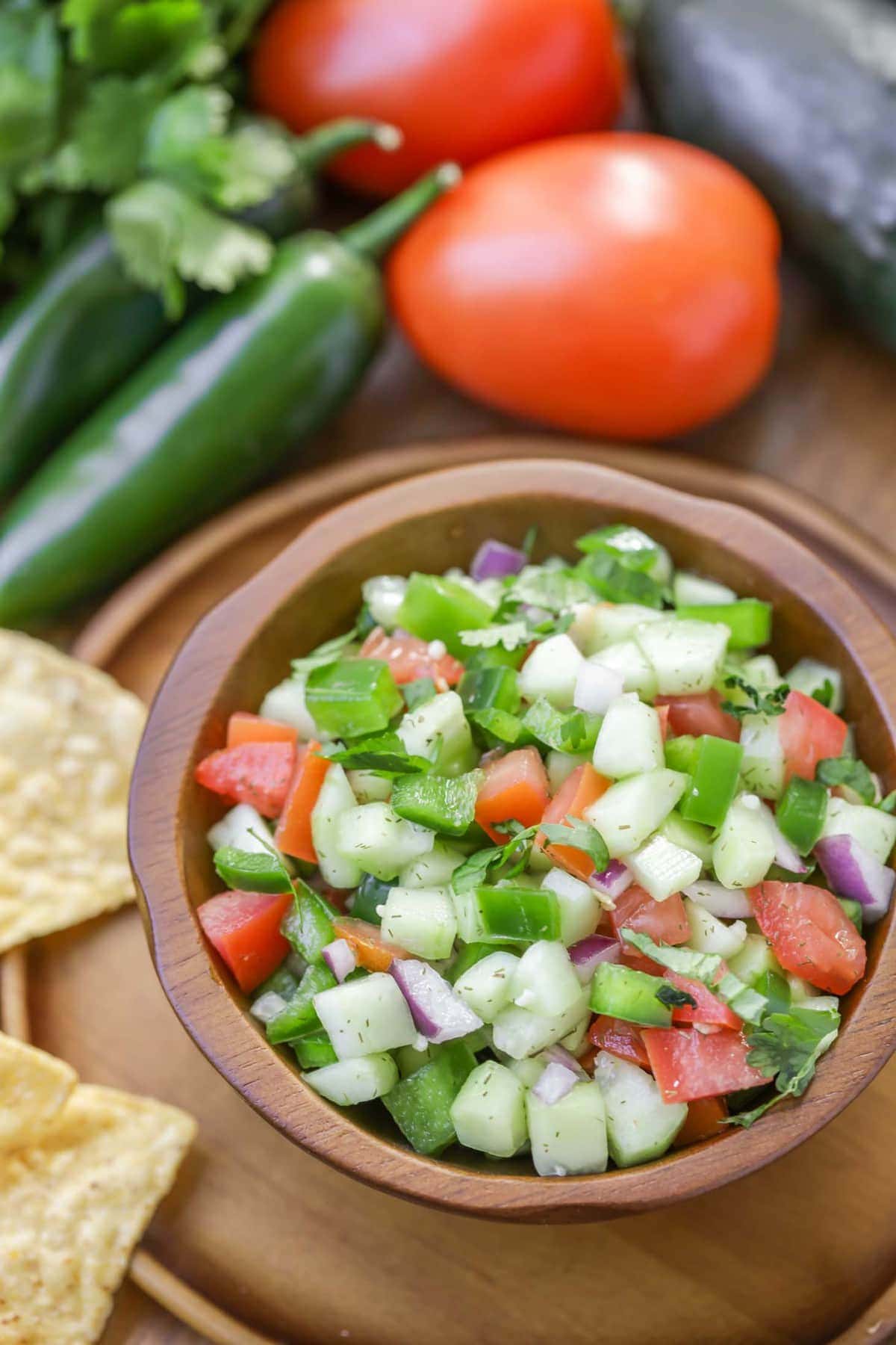 Cucumber salsa in bowl served with tortilla chips.