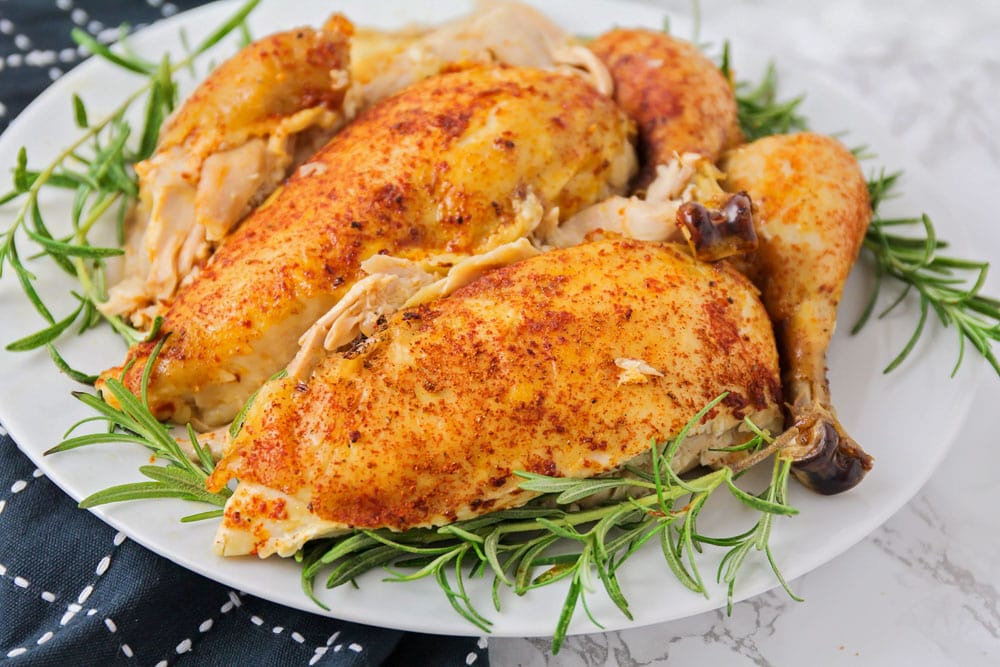 炖锅晚餐的主意-慢炖烤鸡周围迷迭香。
