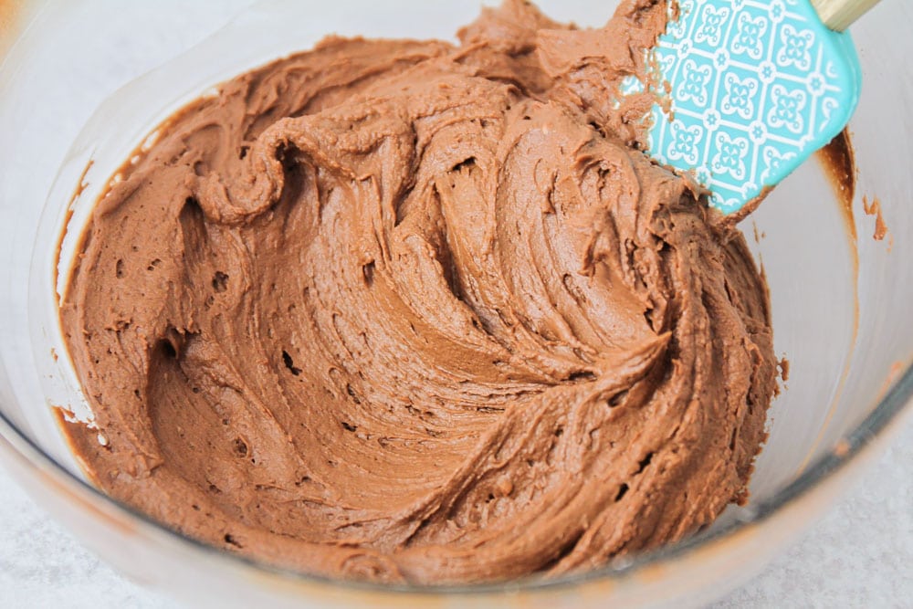 将巧克力奶油糖霜放在搅拌碗中，准备涂抹在巧克力蛋糕食谱上。bob综合手机客户