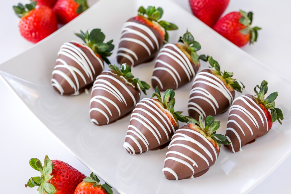 新年夜的甜点——几个巧克力覆盖的草莓排列在一个大盘子上。