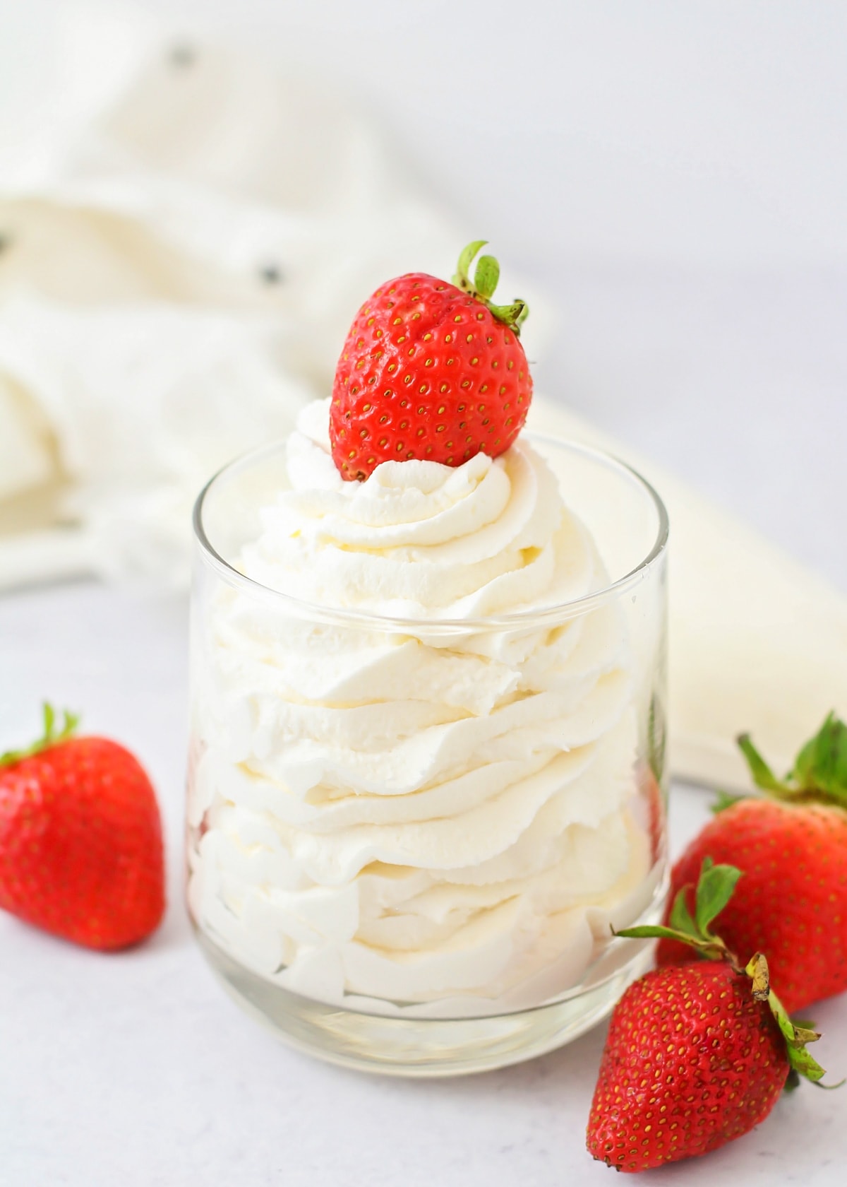 Homemade Whipped Cream Recipe served in a red and white bowl.